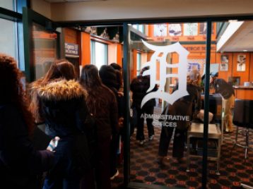 Detroit Tiger's administrative office with students streaming in the door, awaiting a security check.
